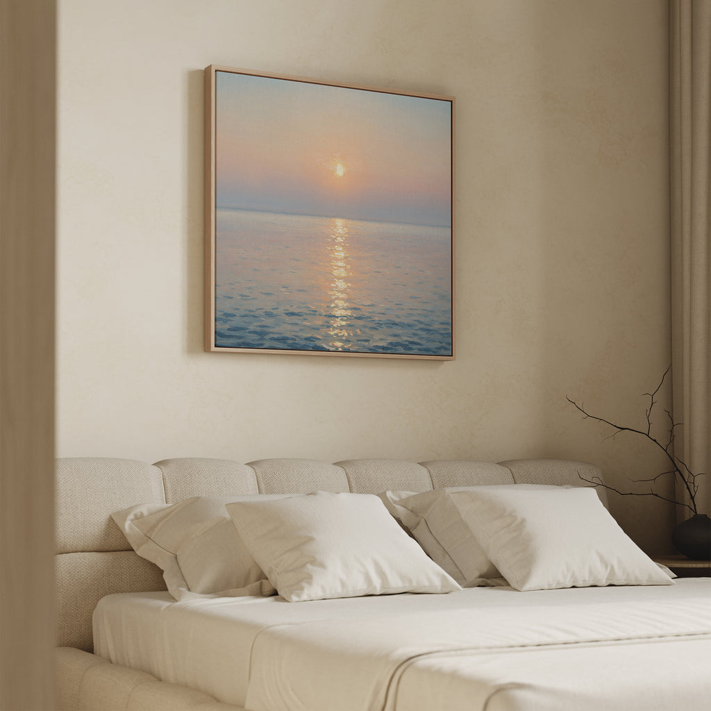 A minimal bedroom features a beige upholstered bed with white pillows. Above, the Golden Reflection Canvas Art - Square adds calming hues, while neutral walls and soft lighting create a tranquil, inviting retreat.