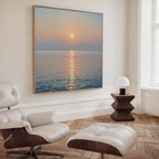 A modern, minimalist room with white walls and wood floors features the Golden Reflection Canvas Art - Square above a white leather lounge chair and ottoman, plus a unique wood side table and small white lamp—perfect for tranquil bedroom decor.