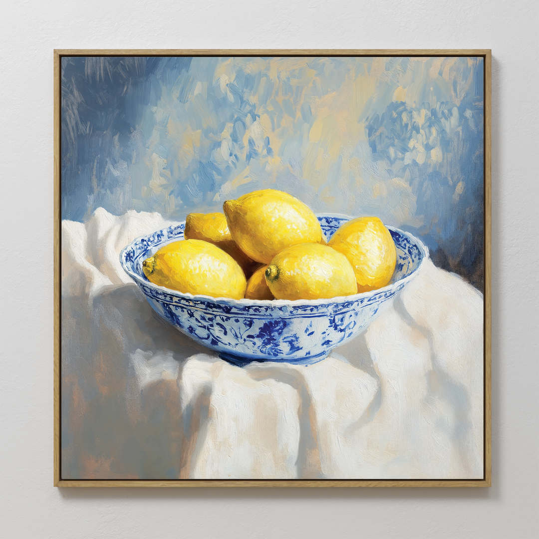 Golden Fruit Canvas Art features a blue and white patterned bowl of yellow lemons on a draped cloth, set against a textured blue and yellow backdrop—ideal rustic kitchen decor and charming lemon wall art.