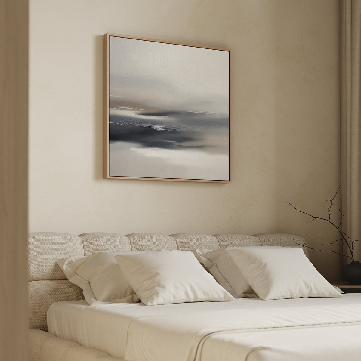 A minimalist bedroom features a beige upholstered bed with white bedding, accented by the Grey Ripples Canvas Art - Square above the headboard. A bare branch in a vase on the bedside table adds to the serene, modern vibe.