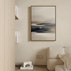 A minimalist living room corner with a beige sofa, shelves with books, a small white geometric decor piece, and the Grey Ripples Canvas Art - Vertical framed and hung on a light-colored wall.