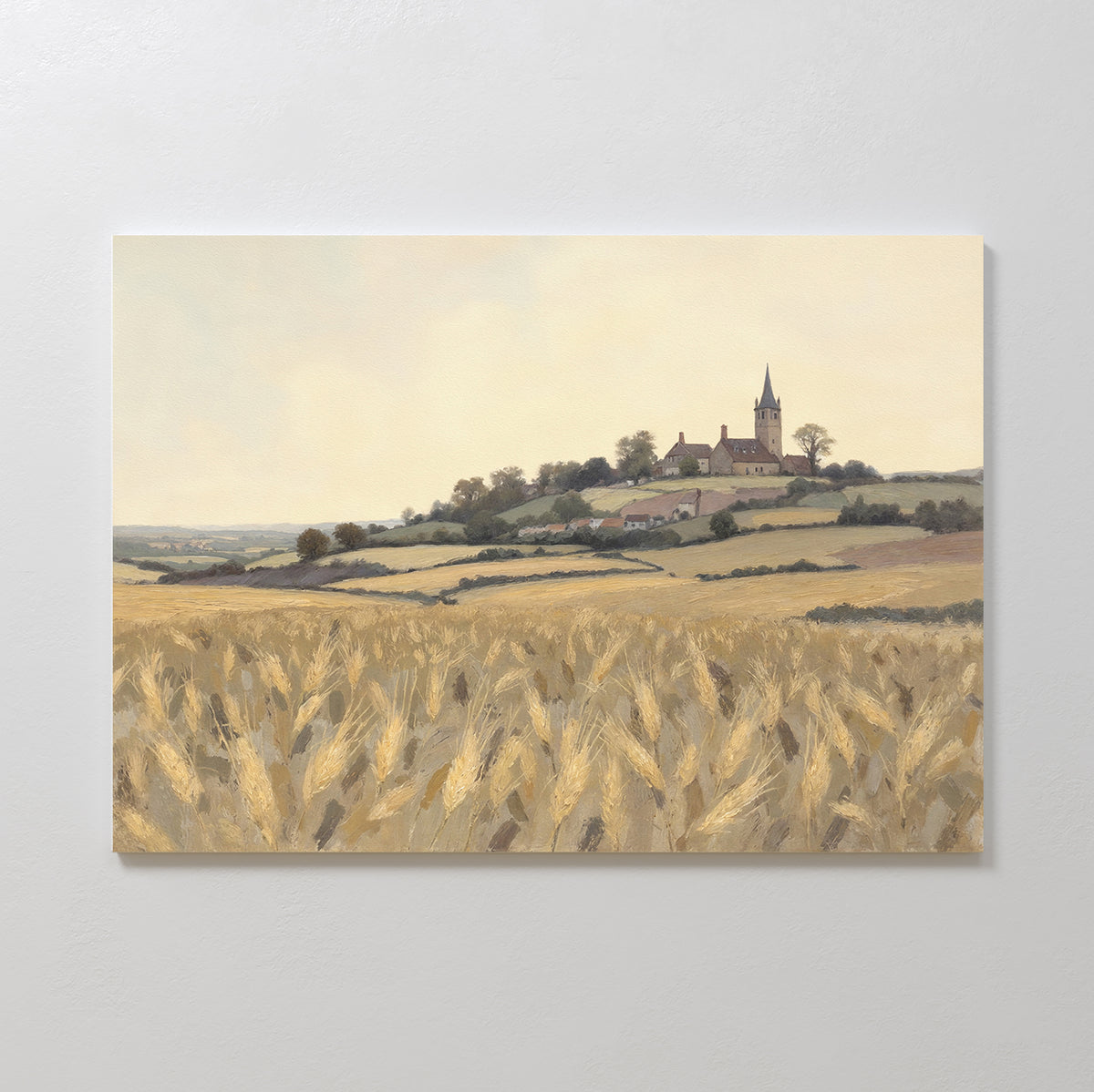 The Harvest Chapel Canvas Art - Horizontal features a golden wheat field with rolling hills, trees, and a church steeple under a pale sky—ideal rustic wall art to enhance any pastoral home decor.
