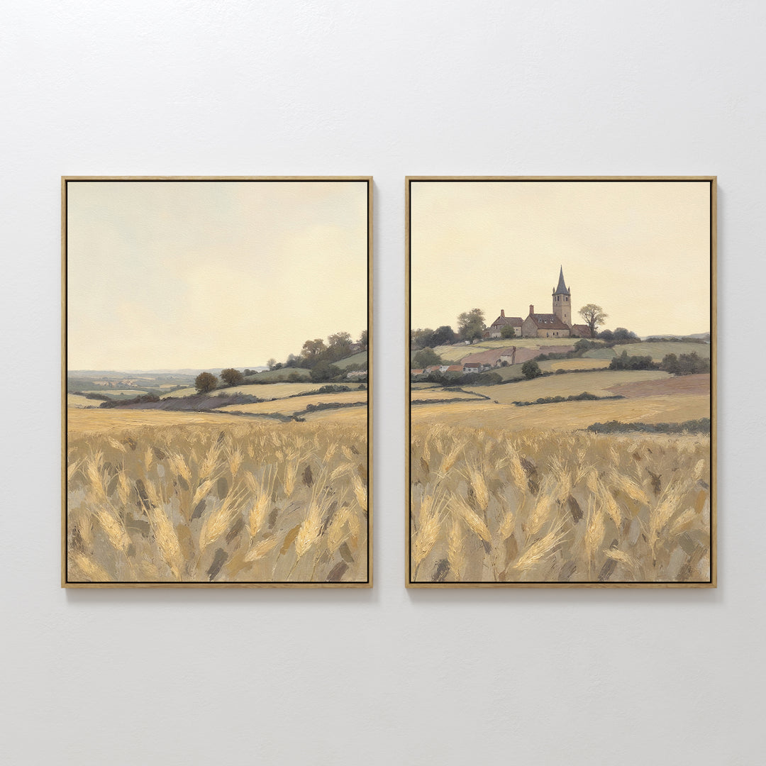 The Harvest Chapel - Set of 2 features framed paintings of a countryside with golden wheat fields, rolling hills, and a distant church under a pale sky, beautifully capturing the rustic charm and tranquility of rural life.
