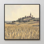 The Harvest Chapel Canvas Art - Square features a golden wheat field with rolling hills, scattered trees, and Harvest Chapel atop a hill beneath a pale, cloudy sky, bringing rustic charm to any space.