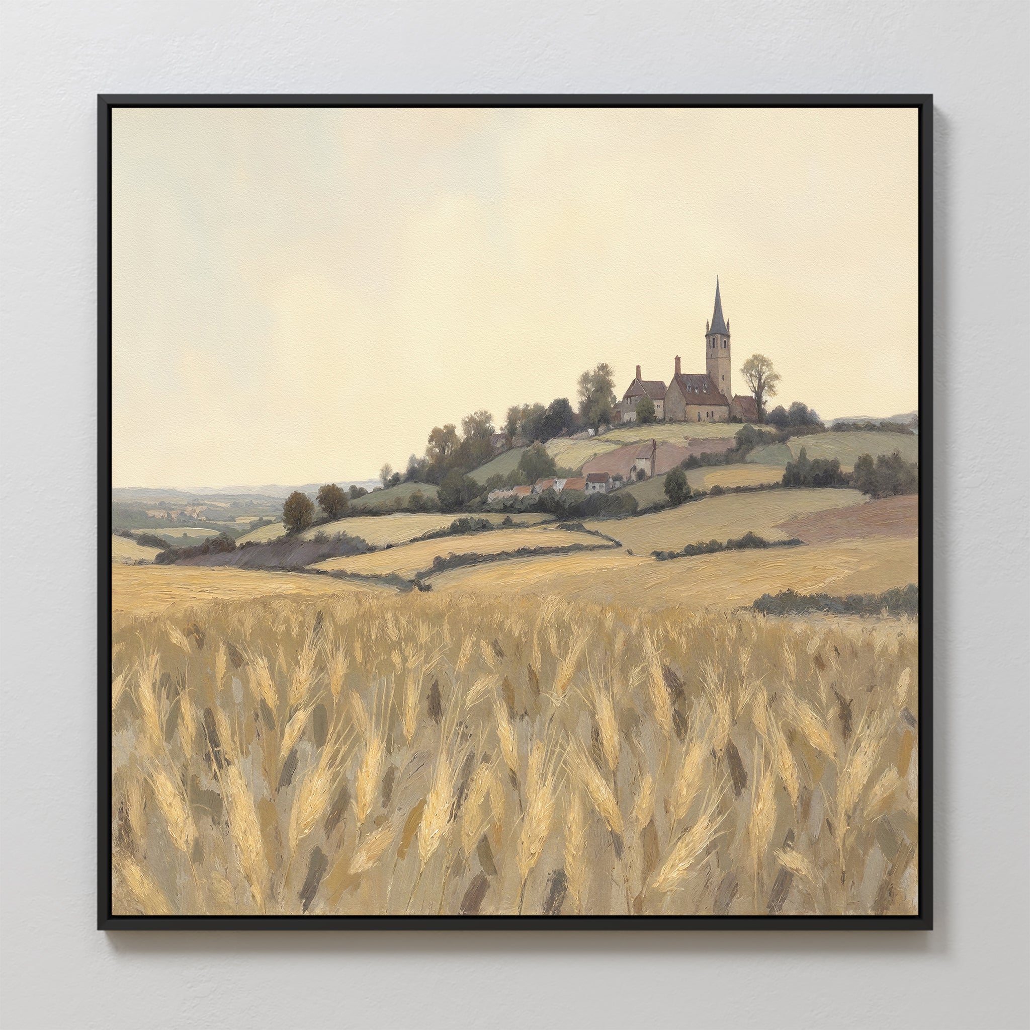 The Harvest Chapel Canvas Art - Square features a golden wheat field with rolling hills, scattered trees, and Harvest Chapel atop a hill beneath a pale, cloudy sky, bringing rustic charm to any space.