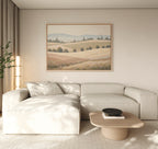 A modern living room with a light beige sectional sofa, wooden coffee table with a black bowl, floor lamp, and Harvest Fields Canvas Art - Horizontal on the wall. Neutral tones create a calm, minimalist atmosphere.