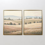 The Harvest Fields - Set of 2 features framed canvases depicting rolling fields, hills, trees, and a soft sky in muted tones—ideal farmhouse decor for a serene, panoramic countryside wall art look.