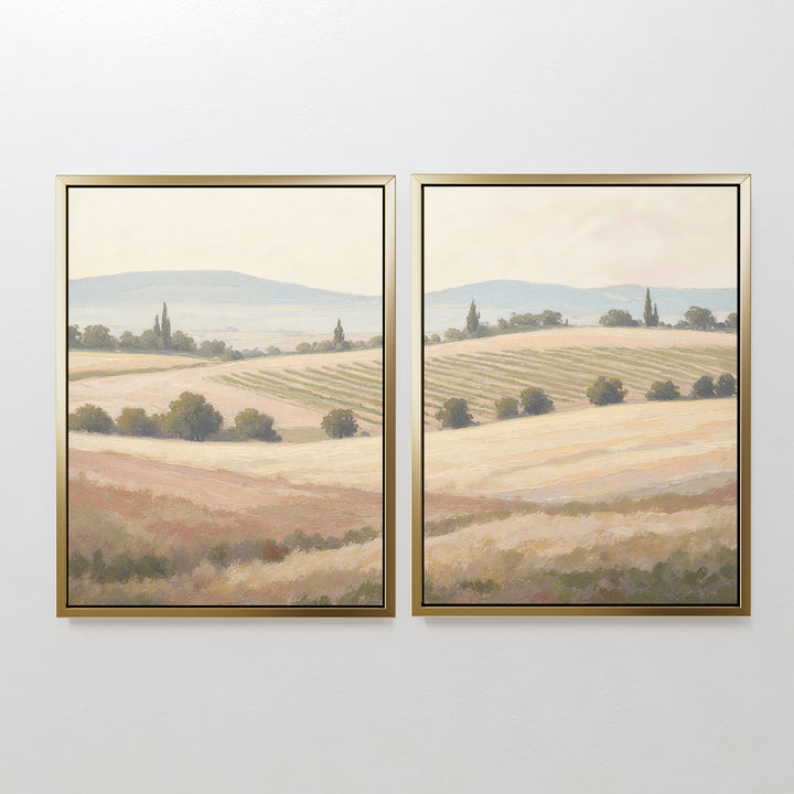 The Harvest Fields - Set of 2 features framed canvases depicting rolling fields, hills, trees, and a soft sky in muted tones—ideal farmhouse decor for a serene, panoramic countryside wall art look.