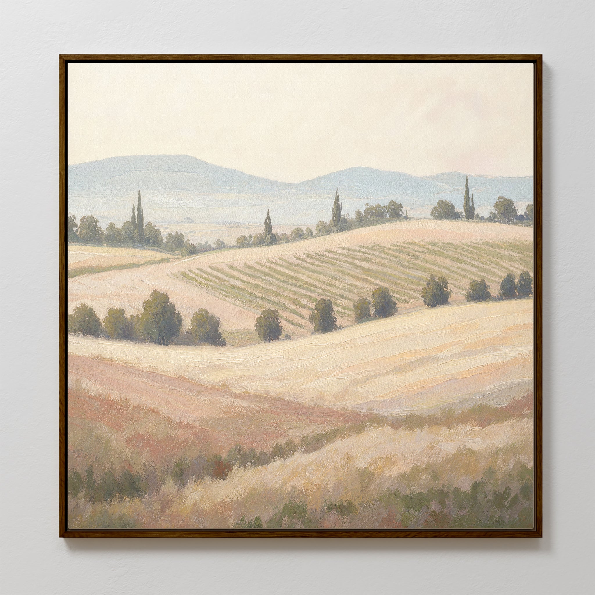 Add a touch of elegance to your space with the Harvest Fields Canvas Art - Square, featuring a soft countryside landscape with rolling hills, scattered trees, and distant mountains—ideal wall art for sophisticated country-inspired decor.