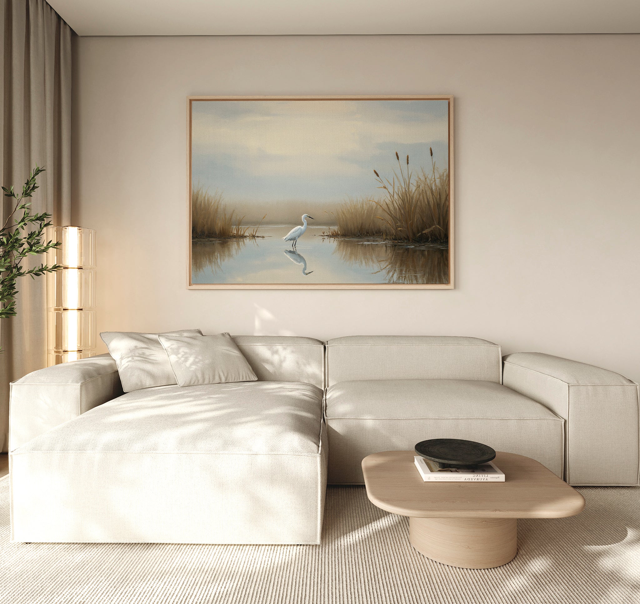A modern living room with a beige sectional, a light wood coffee table, and the Heron's Morning Canvas Art - Horizontal above the sofa. Soft natural light enhances the serene atmosphere.