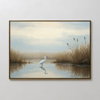 The Heron's Morning Canvas Art - Horizontal features a white heron in shallow water among golden reeds, with a calm sky reflected on the surface—an ideal serene wall art piece.
