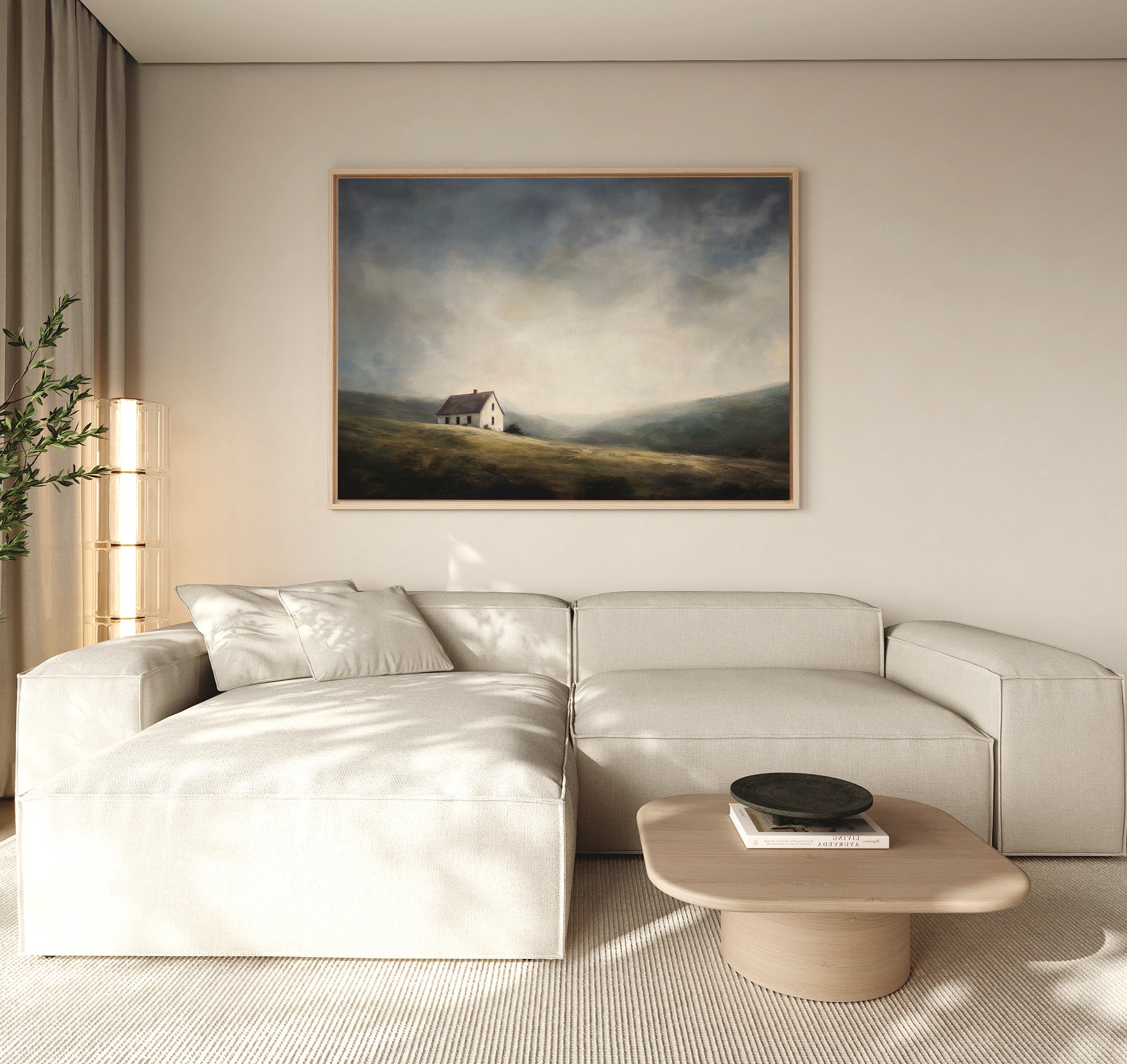 A modern living room with a light beige sectional, wooden coffee table, sheer curtains, and the Highland Solitude Canvas Art - Horizontal depicting moody landscape and rustic tranquility on a pale wall.