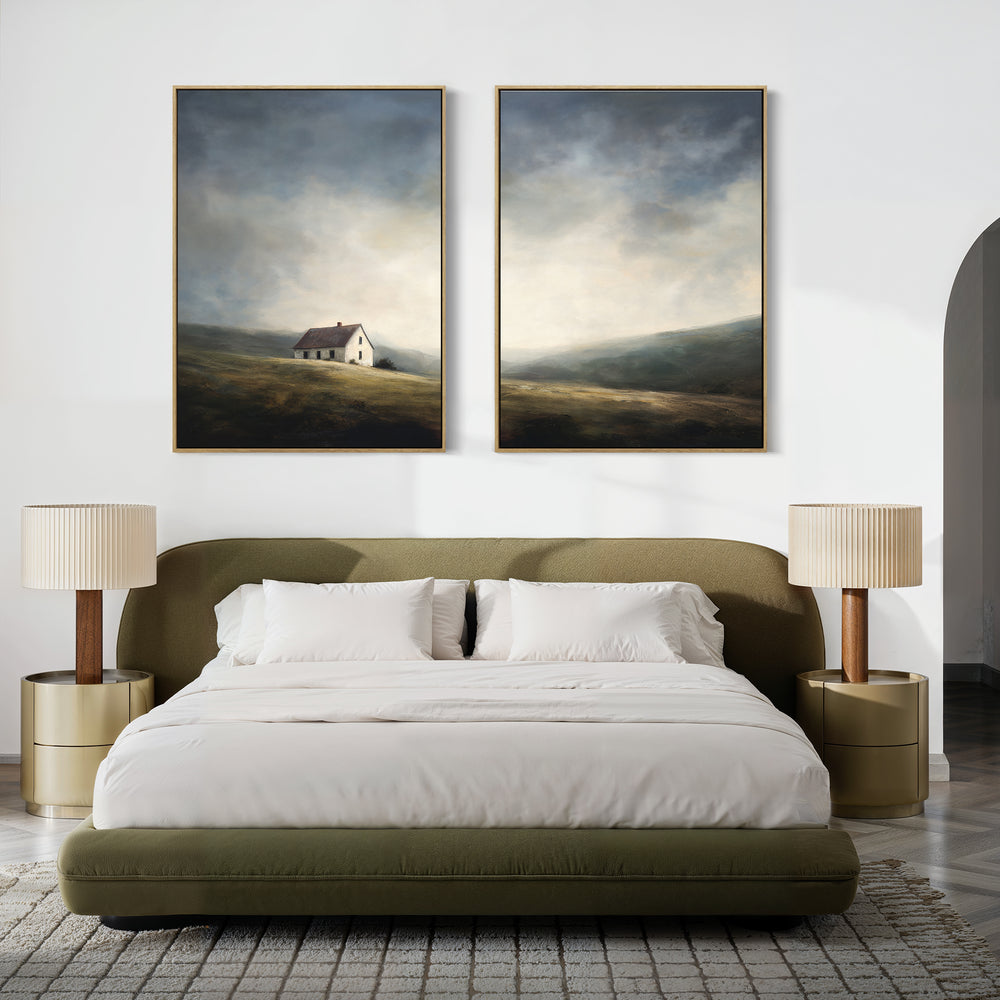 A modern bedroom with a green upholstered bed, white bedding, two beige nightstands and matching lamps, featuring Highland Solitude - Set of 2 canvas prints—rustic art of a house and rolling hills under a moody sky.