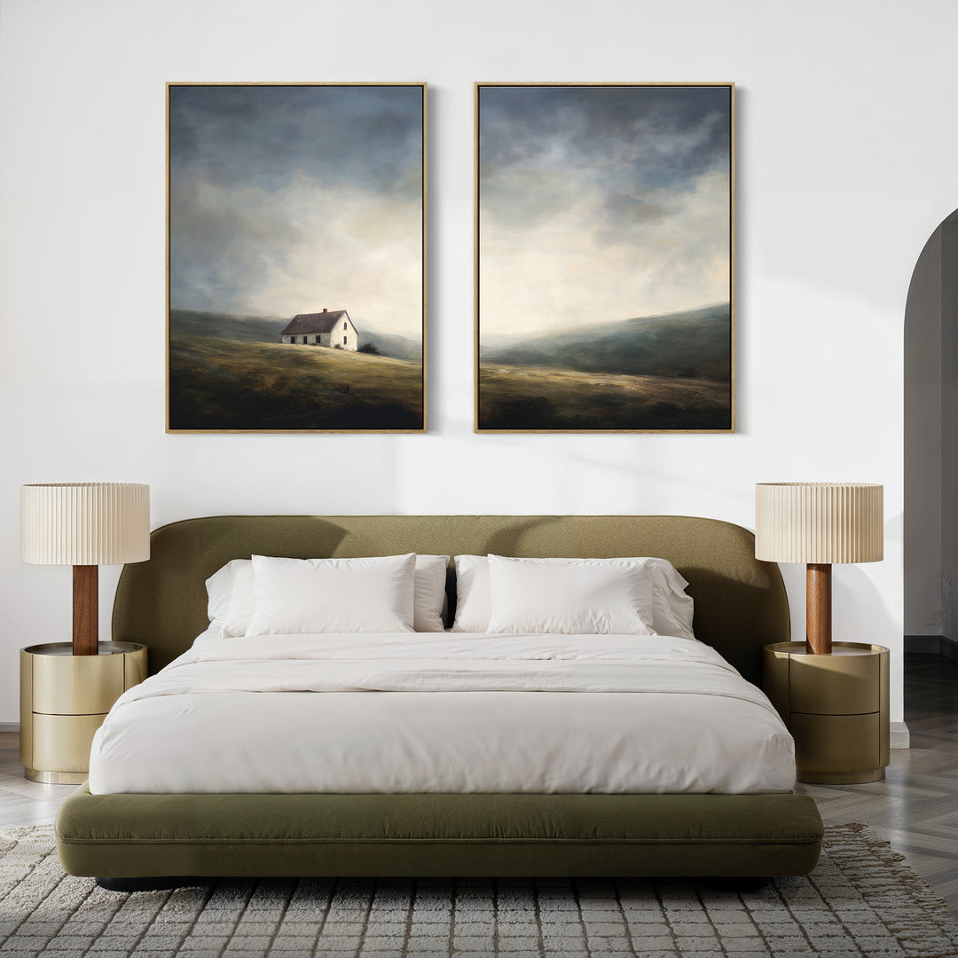 A modern bedroom with a green upholstered bed, white bedding, two beige nightstands and matching lamps, featuring Highland Solitude - Set of 2 canvas prints—rustic art of a house and rolling hills under a moody sky.