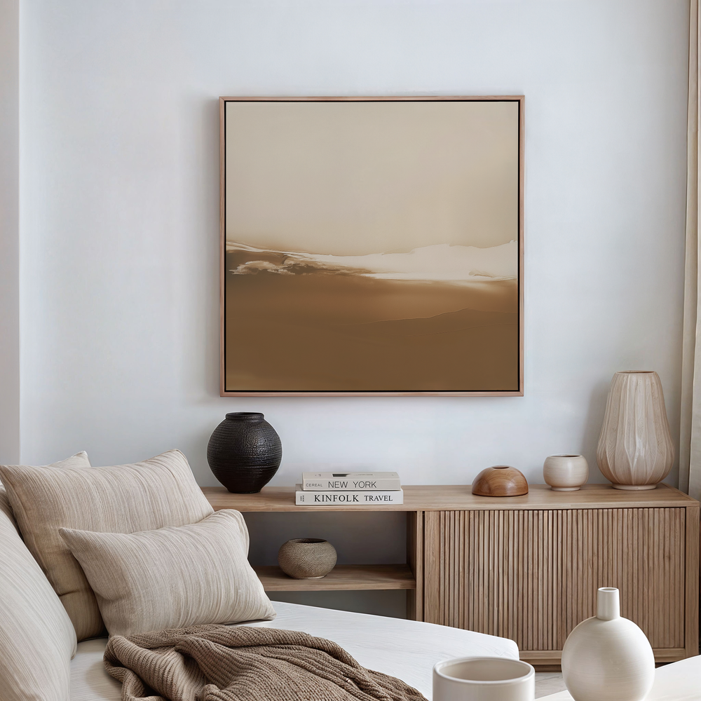 A minimalist, neutral-toned living room features a beige sofa with striped pillows, a wooden sideboard adorned with vases and books, and the Desert Dusk Abstract Canvas Art displayed above as calming wall decor.
