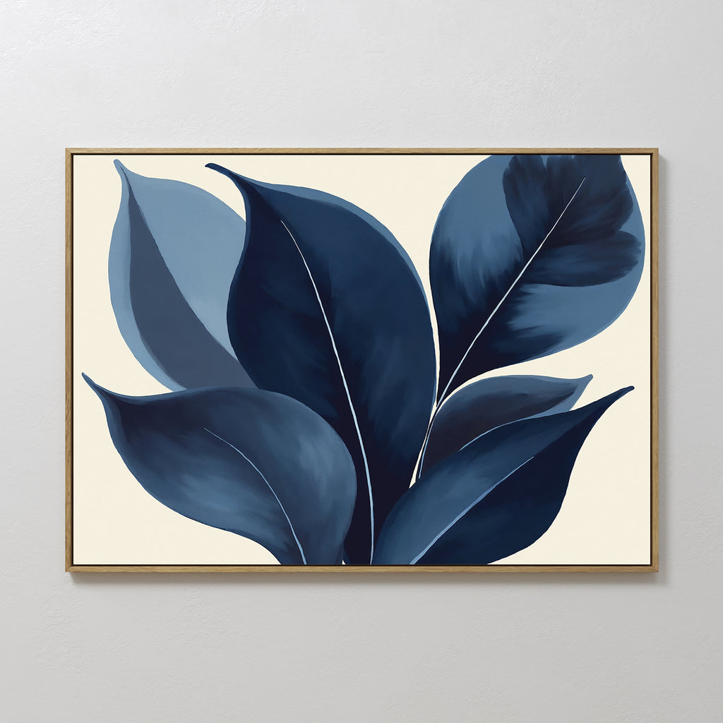Indigo Depths Canvas Art - Horizontal features large blue leaves in navy botanical style with layered dark and light tones on a cream background, set in a slim gold frame—an elegant accent for any plain white wall.