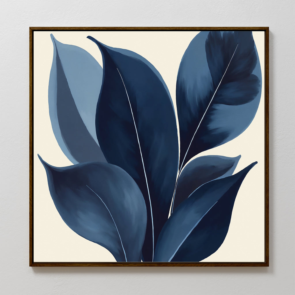 The Indigo Depths Canvas Art - Square features large, stylized navy and blue leaves on a light beige background. Crisp lines and a minimalist design make this framed piece an elegant, modern addition to any room.