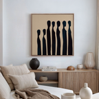 A modern living room with a beige sofa, patterned cushions, wooden sideboard, ceramic vases, books, and minimalist Indigo Profile Abstract Canvas Art—perfect for stylish decor.