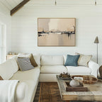 A cozy living room with a white sectional sofa, assorted pillows, a rustic wooden coffee table with decor, floor lamp, and Industrial Cityscape Canvas Art - Horizontal on the white shiplap wall. Natural light streams in from the left.