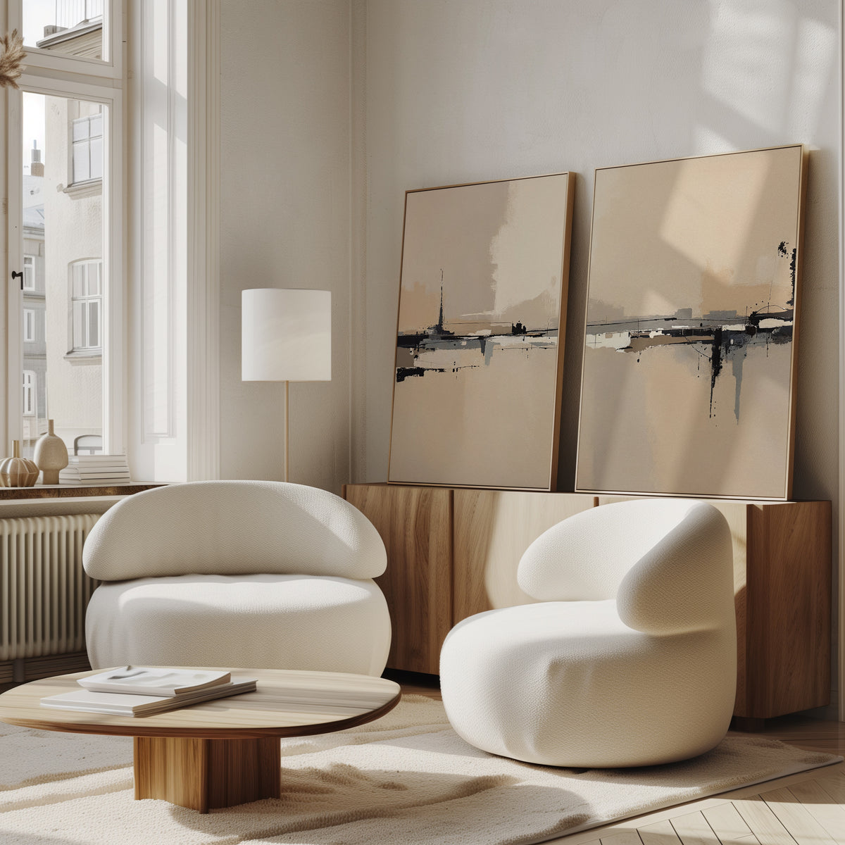 A modern living room with two rounded white chairs, a low wooden coffee table, large windows, and the Industrial Cityscape - Set Of 2 artwork leaning against the wall, filling the space with natural light.