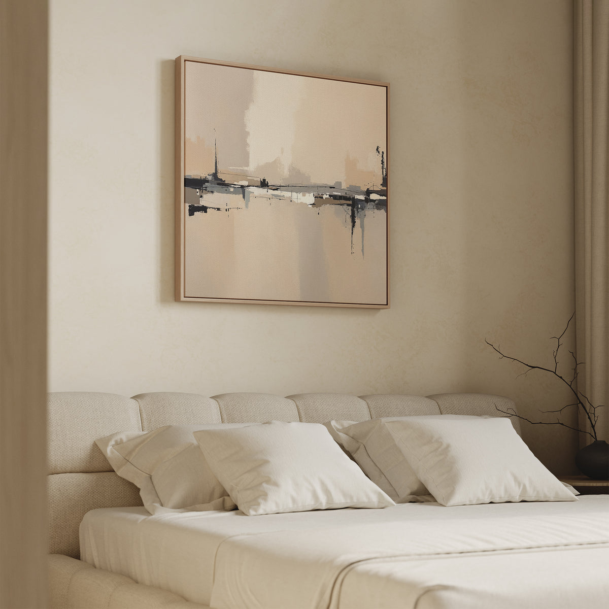A minimalist bedroom with a beige upholstered bed, four white pillows, and a beige blanket. Above the bed hangs the Industrial Cityscape Canvas Art - Square. A bare branch in a vase sits on the bedside table.