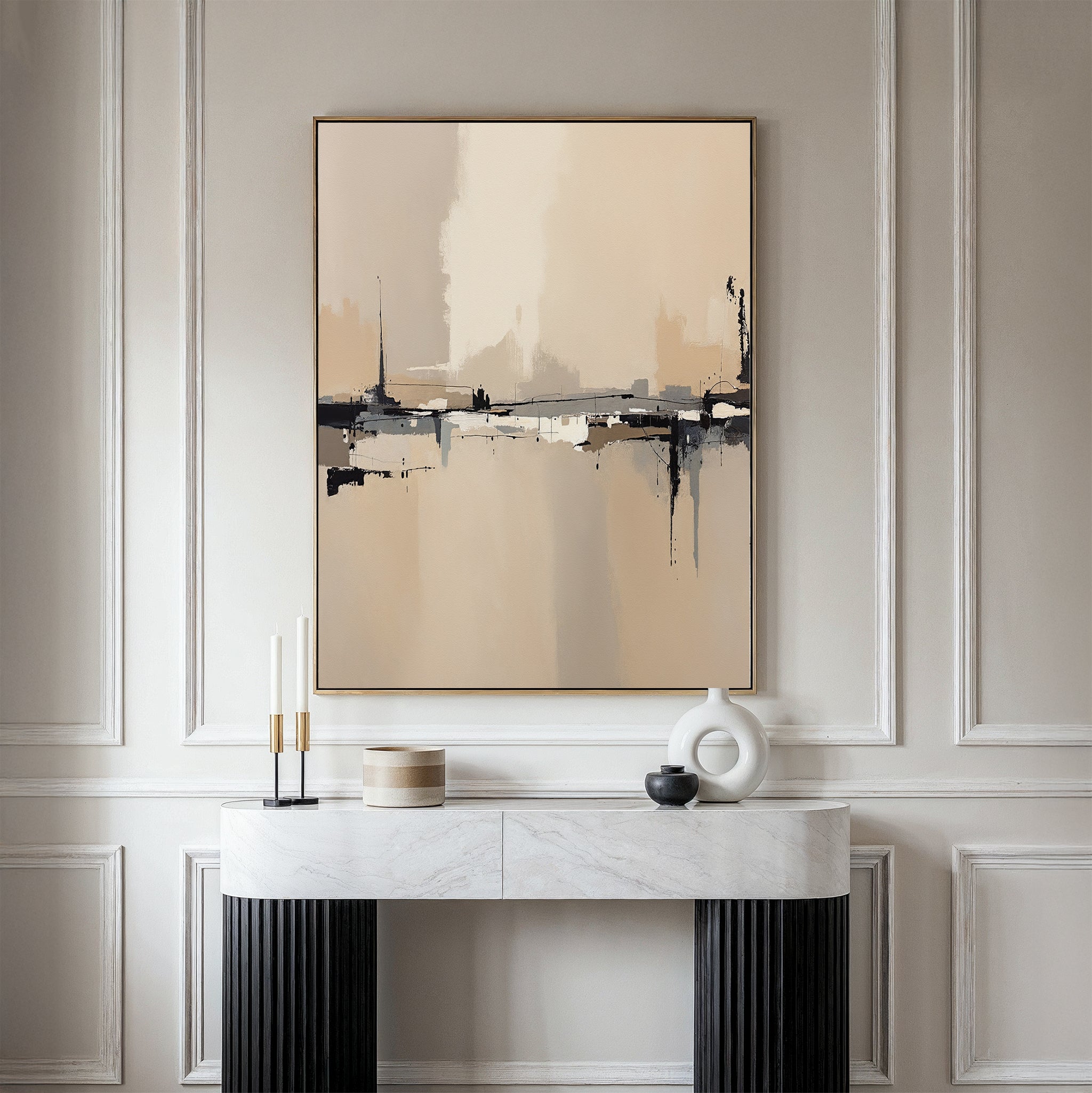 A minimalist console table with modern decor stands against a creamy paneled wall, topped by the Industrial Cityscape Canvas Art - Vertical, whose abstract city design in neutral tones adds sophistication to the elegant space.