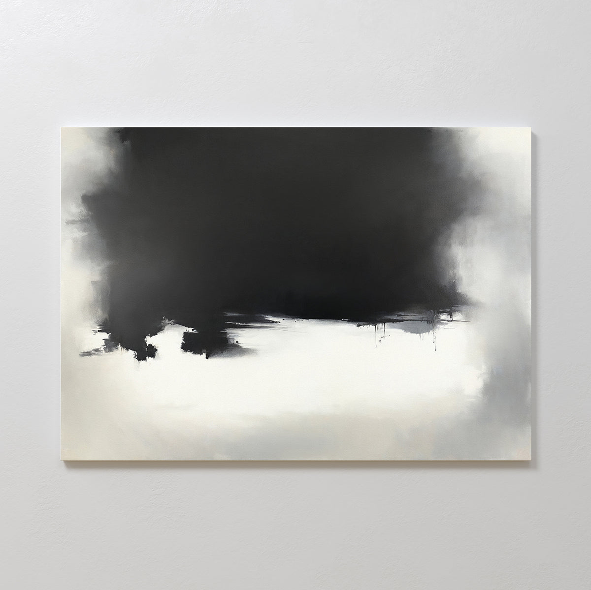 The Ink Cloud Formation Canvas Art - Horizontal features a dark black upper section blending into gray and white beneath, creating a sleek, modern look; this monochrome artwork is displayed on a light-colored wall.