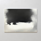 The Ink Cloud Formation Canvas Art - Horizontal features a dark black upper section blending into gray and white beneath, creating a sleek, modern look; this monochrome artwork is displayed on a light-colored wall.