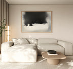 A modern living room featuring a light beige sectional sofa, low wooden coffee table with black bowl, tall lamp, potted plant, and the Ink Cloud Formation Canvas Art - Horizontal adding sophisticated style to the wall.