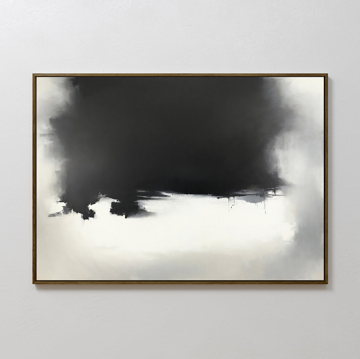 The Ink Cloud Formation Canvas Art - Horizontal features a bold black and dark gray cloud form above soft whites and grays, creating a sleek monochrome look, elegantly framed in brown and showcased on a light gray wall.