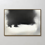 The Ink Cloud Formation Canvas Art - Horizontal features a bold black and dark gray cloud form above soft whites and grays, creating a sleek monochrome look, elegantly framed in brown and showcased on a light gray wall.