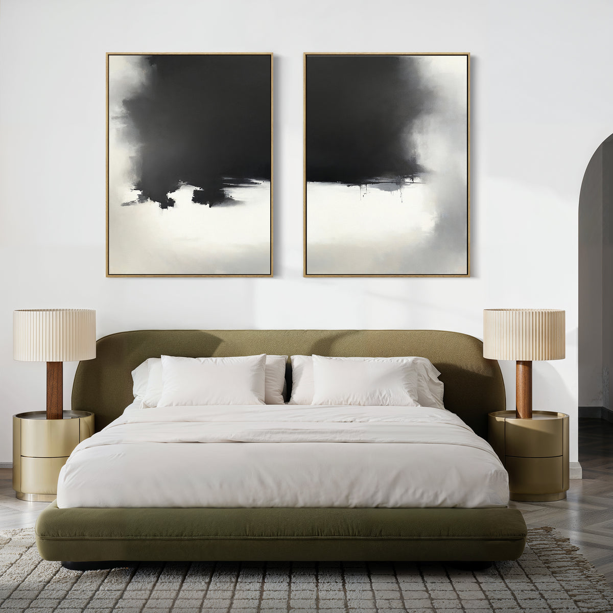 Contemporary bedroom with a low olive-green bed, white bedding, gold nightstands with pleated lamps, and modern decor. Above the headboard hangs the Ink Cloud Formation - Set Of 2: large black-and-white abstract wall art.