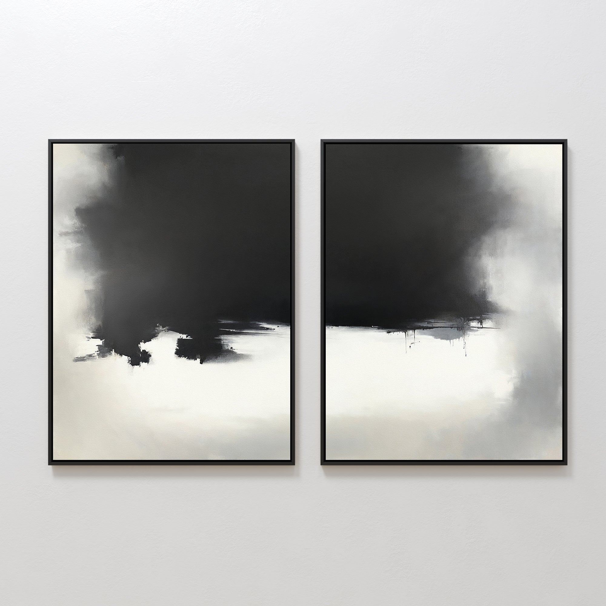 The "Ink Cloud Formation - Set Of 2" features two framed modern wall art prints with bold, dark cloud-like shapes blending into lighter areas, creating a striking black and white contrast on your wall.