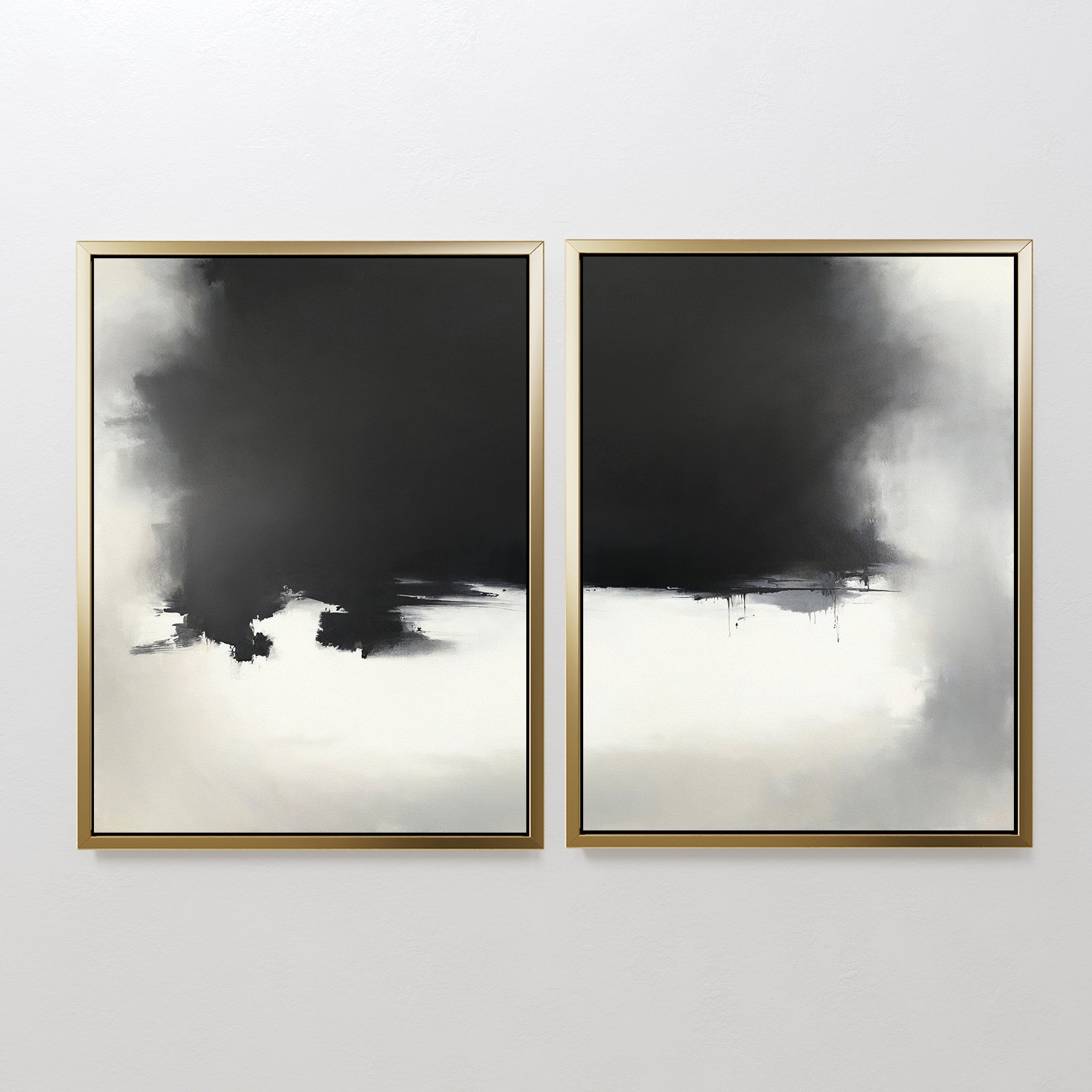 Ink Cloud Formation - Set Of 2 features modern wall art with moody black and gray ink clouds blending into white backgrounds. Each piece has a gold frame, and together they create an elegant, atmospheric effect with softly blurred edges.