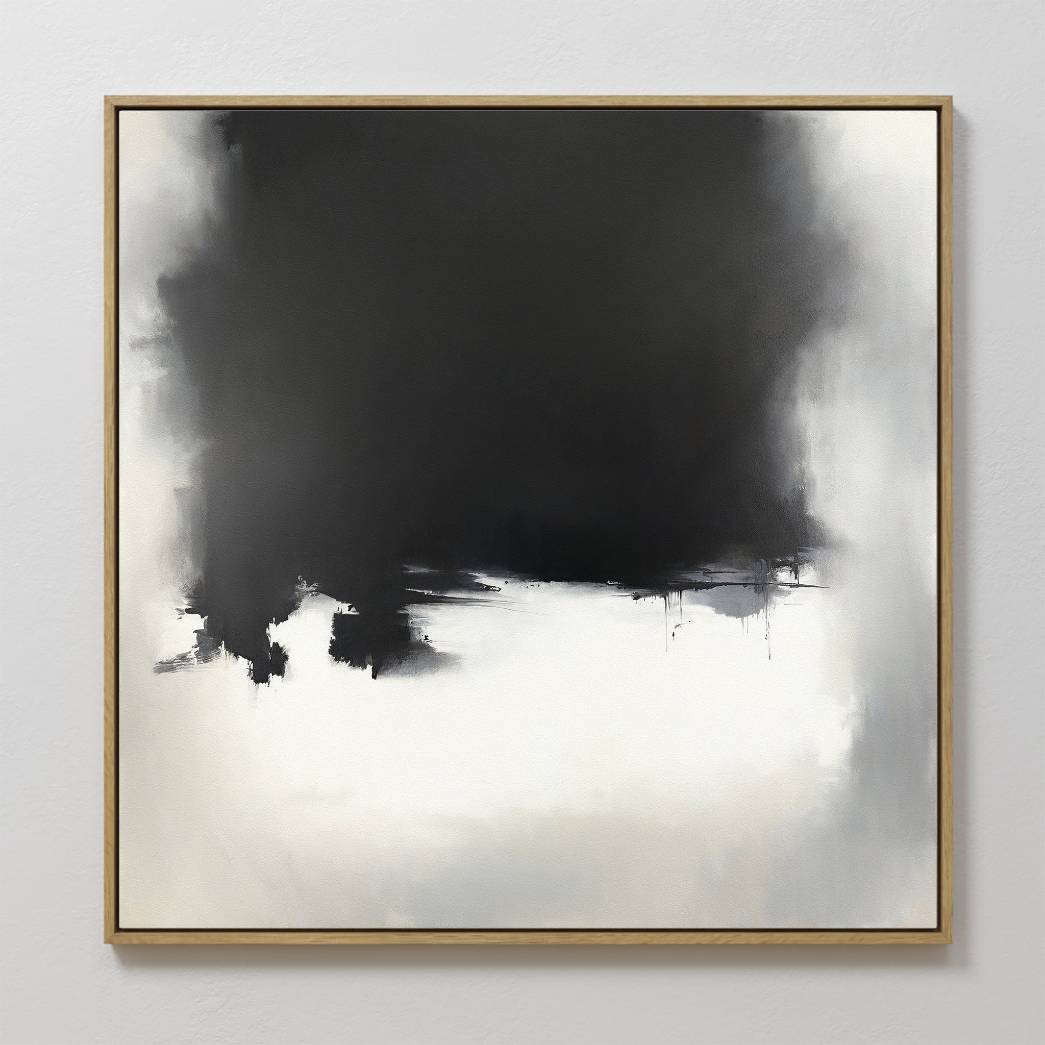 Ink Cloud Formation Canvas Art - Square features a bold black section merging into soft gray and white, creating a misty, cloud-like effect. This monochrome print with a gold frame adds modern sophistication to any space.