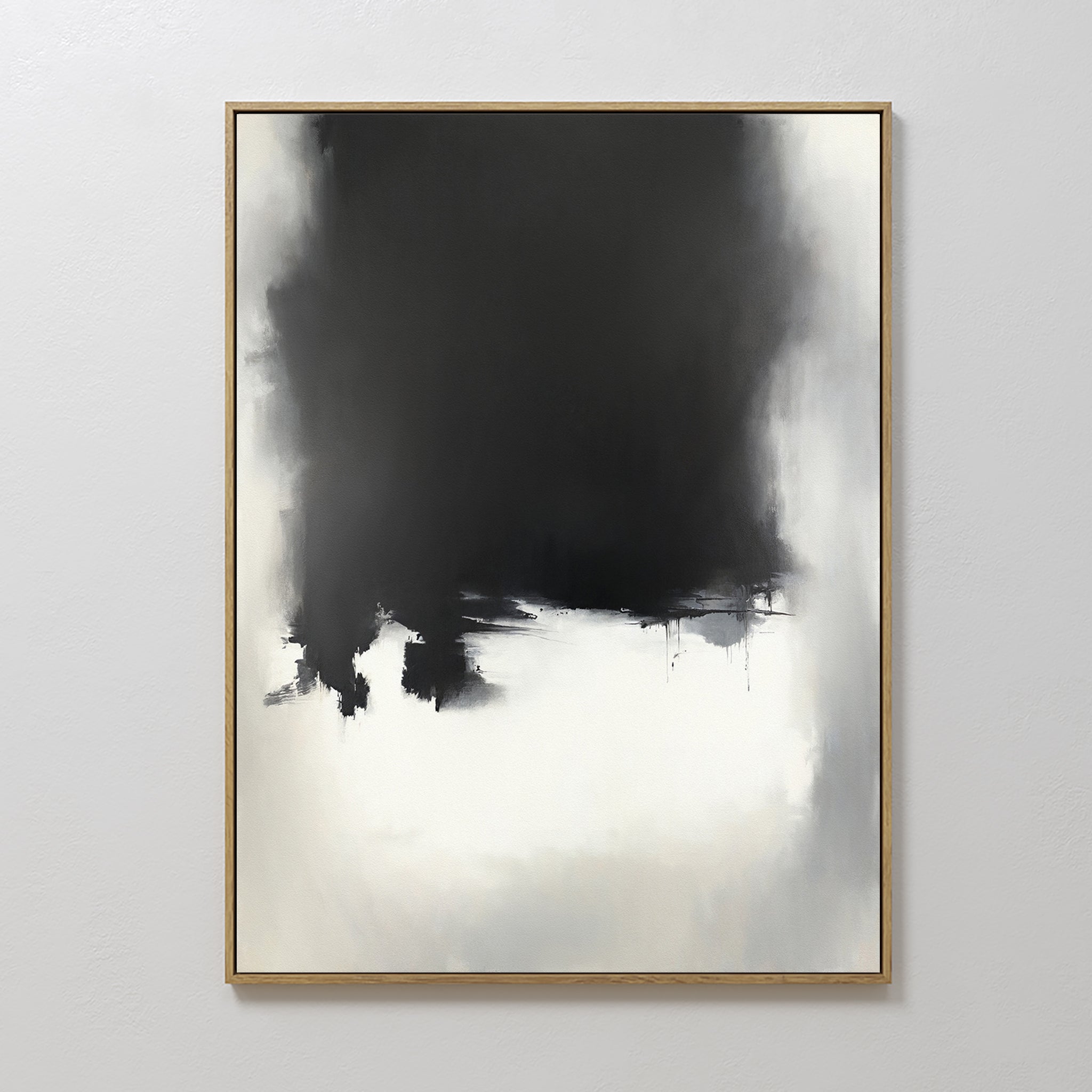The Ink Cloud Formation Canvas Art - Vertical showcases a large, irregular black shape merging into gray and white tones on a white background. Framed in thin wood, this monochrome piece brings modern sophistication to any wall.