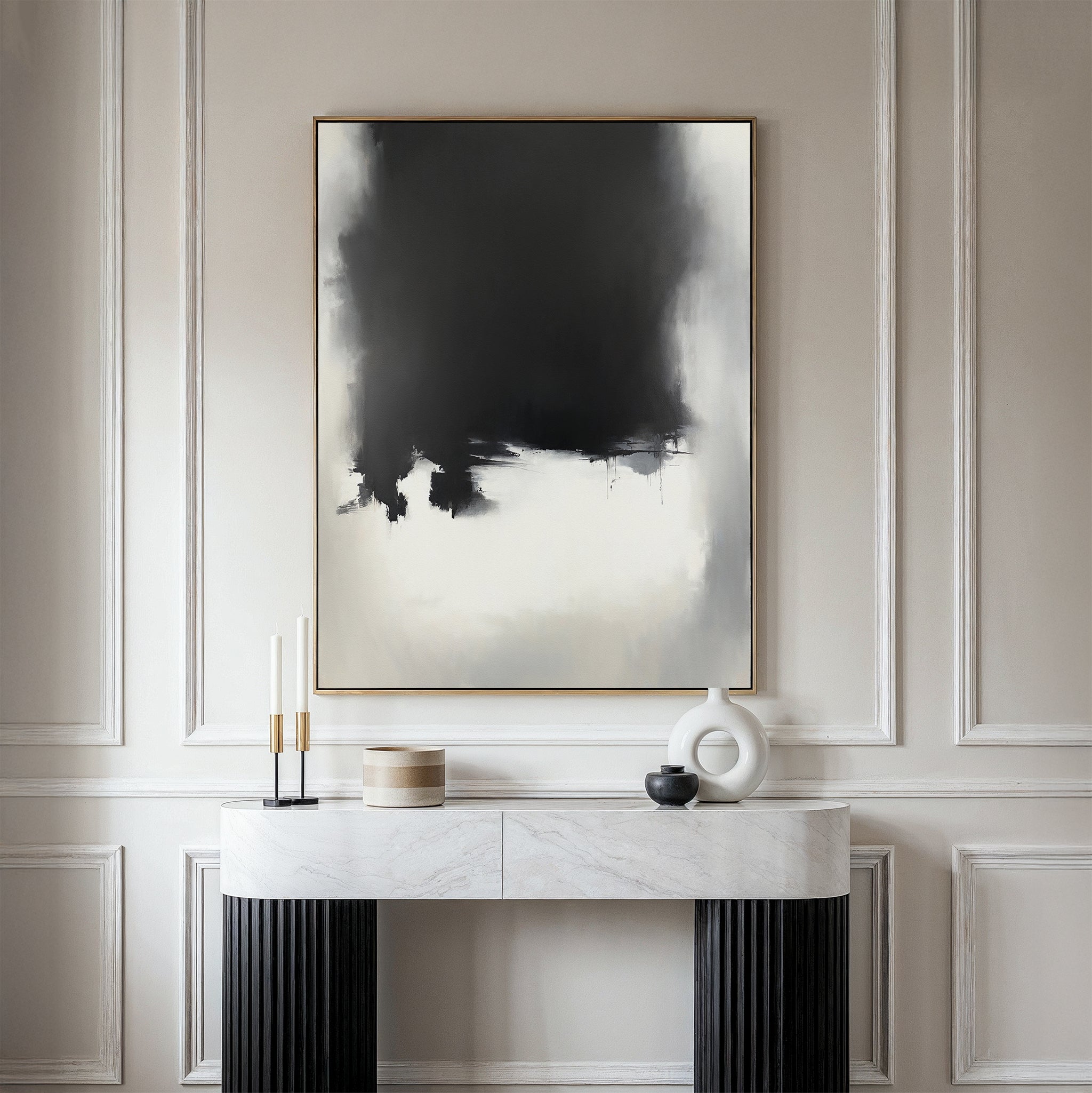 A minimalist entryway features a marble console table, decorative objects, and the Ink Cloud Formation Canvas Art - Vertical on a wall with elegant panel molding for a touch of modern sophistication.