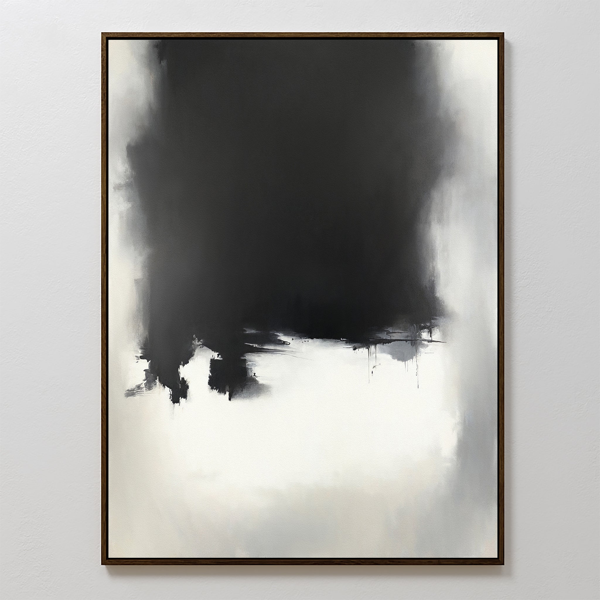 Ink Cloud Formation Canvas Art - Vertical features a large black mass at the top blending into light gray and white below, with soft edges and subtle drips. This monochrome print exudes modern sophistication in a thin, simple wooden frame.