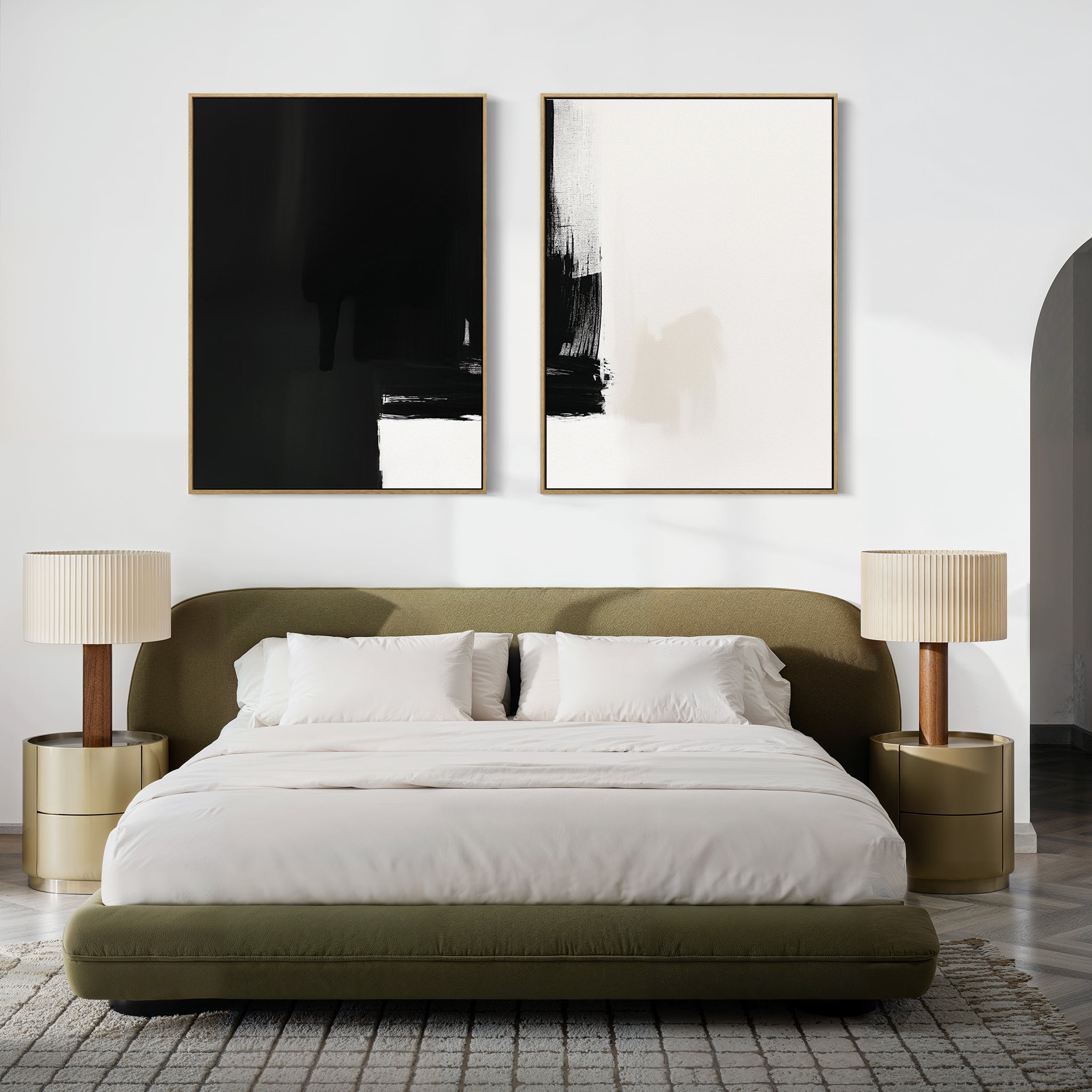 A modern bedroom features an olive green upholstered bed, white bedding, beige nightstands with matching lamps, and the Ink Divide - Set Of 2 black-and-white wall art above the headboard for a touch of contemporary elegance.