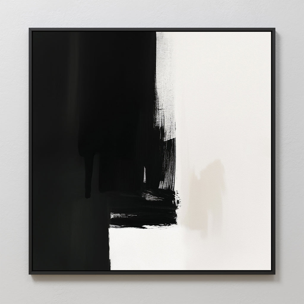 The Ink Divide Canvas Art - Square features bold black brushstrokes on the left fading into a white background, with subtle textures and sharp contrast. This contemporary minimalist piece is elegantly framed in black.