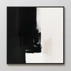 The Ink Divide Canvas Art - Square features bold black brushstrokes on the left fading into a white background, with subtle textures and sharp contrast. This contemporary minimalist piece is elegantly framed in black.
