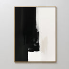 The Ink Divide Canvas Art - Vertical features bold black brushstrokes blending into white with textured, uneven edges, epitomizing minimalist wall art. Hung on a plain white wall, its striking abstract design makes a modern statement.