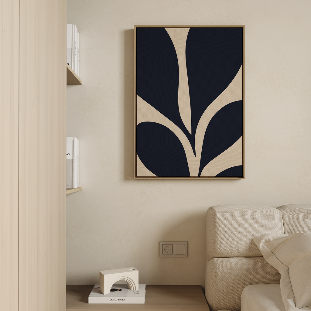 Minimalist living room decor with a beige sofa, small wooden table, and Botanical Ink Abstract Canvas Art in navy and beige tones displayed above the sofa on a light textured wall.