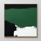 The Jade Depths Canvas Art - Square features an abstract design with a prominent emerald green section, black lower left area, and a bold white brushstroke. This contemporary piece is framed in light wood and shown against a pale wall.