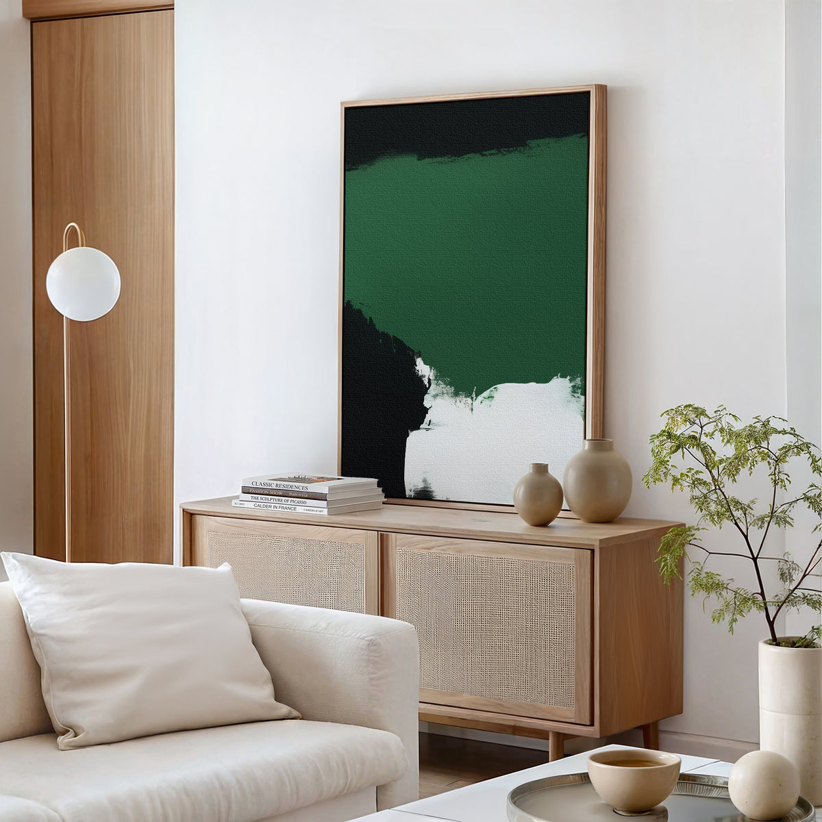 A modern living room with a light sofa, wooden sideboard, ceramic vases, a small potted plant, and the Jade Depths Canvas Art - Vertical adds a fresh touch to the space, combining bold style with contemporary décor.