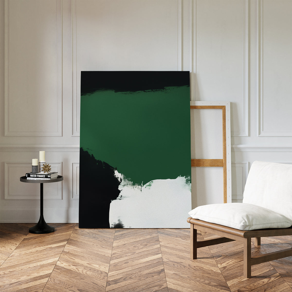 A modern room with herringbone wood floors, white paneled walls, a cushioned chair, a small round table with candles, and the Jade Depths Canvas Art - Vertical leaning against the wall—perfect for modern living room decor.
