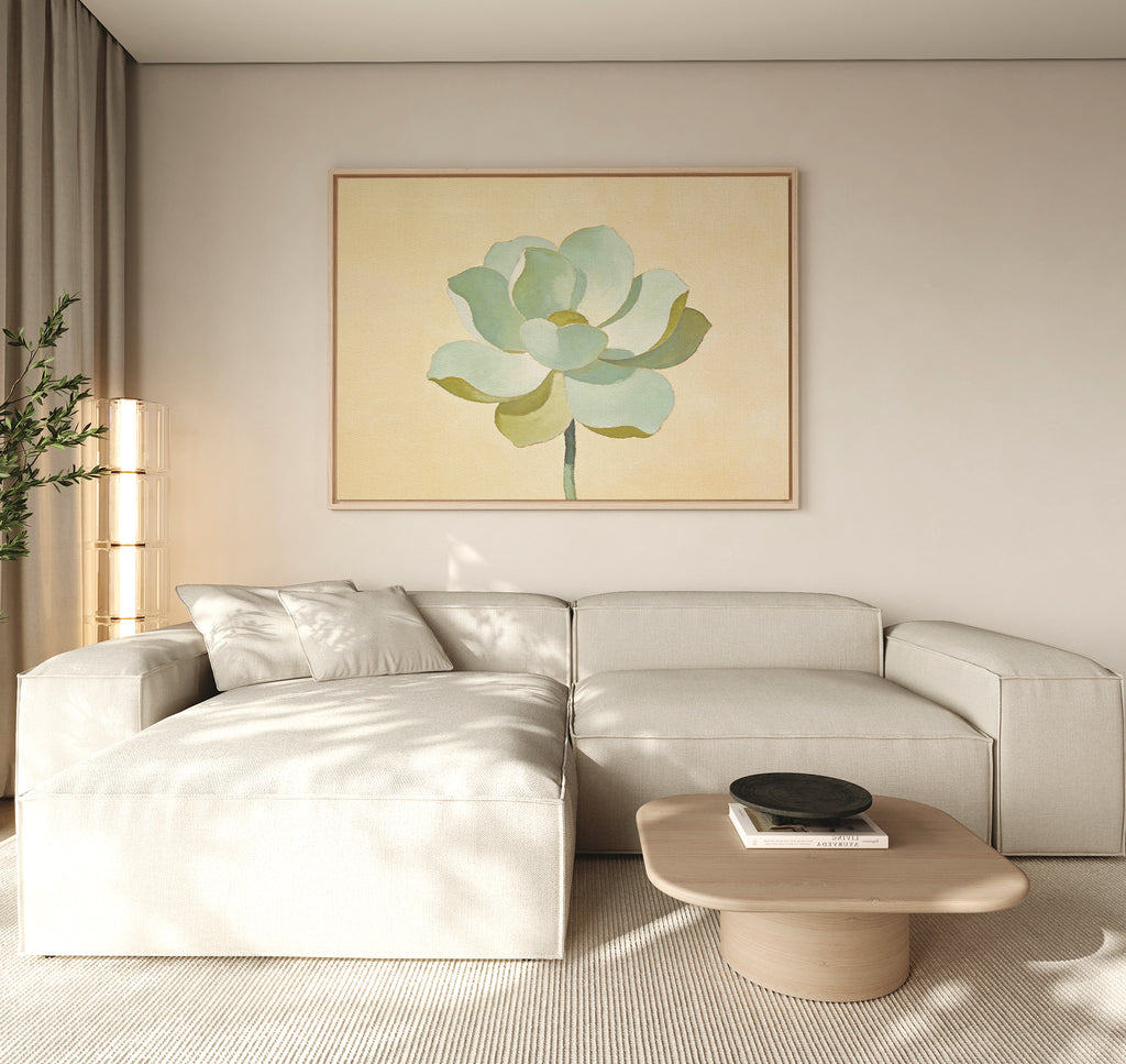 A modern living room features a light beige sectional, a light wood coffee table, and the Jade Reflection Canvas Art - Horizontal above the sofa. Neutral tones, sage green accents, and soft natural light create an inviting atmosphere.
