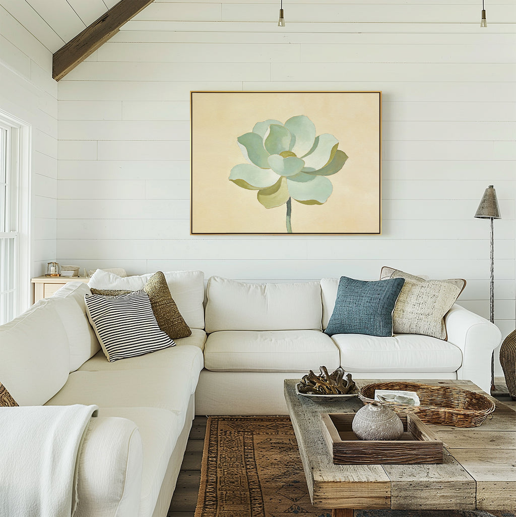 A bright living room with white shiplap walls, a white sectional sofa and assorted pillows, sage green decor, a rustic wooden coffee table, and the Jade Reflection Canvas Art - Horizontal hanging above the sofa.