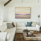 Bright, cozy living room with a white sectional sofa, neutral pillows, rustic wooden coffee table, and the Lavender Valley Canvas Art - Horizontal on the shiplap wall. Natural light streams in from large windows on the left.