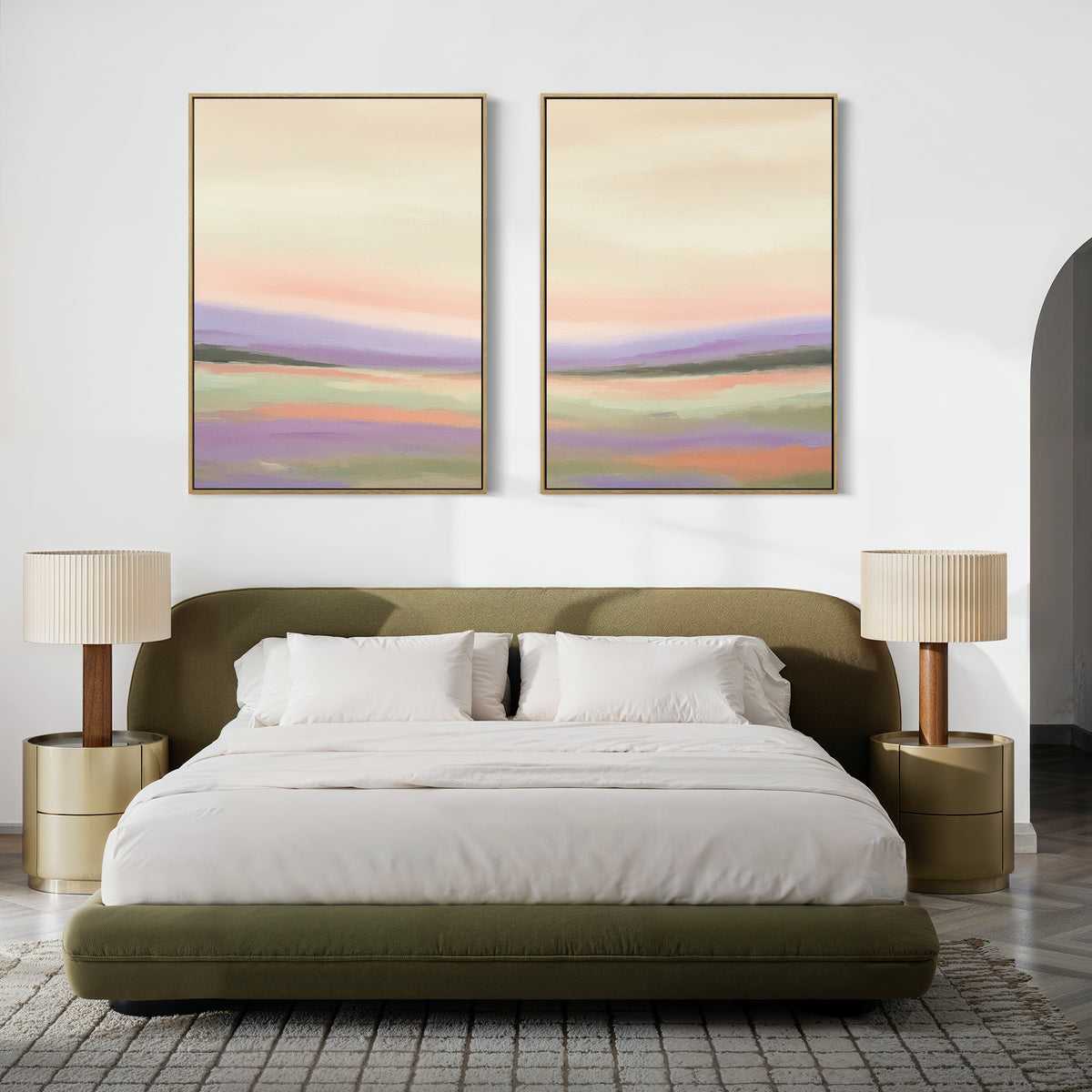 A modern bedroom with an olive green bed, white bedding, two gold nightstands and beige lamps, and "Lavender Valley - Set Of 2" pastel wall art—one featuring a lavender landscape—displayed above the bed.